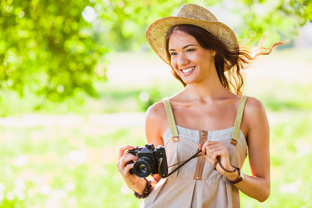Happy young girl with camera outdoors - Foto, Imagem