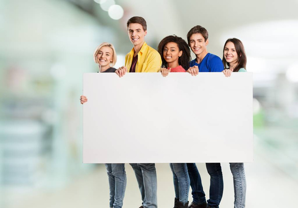 group of happy young people holding blank banner - Photo, Image