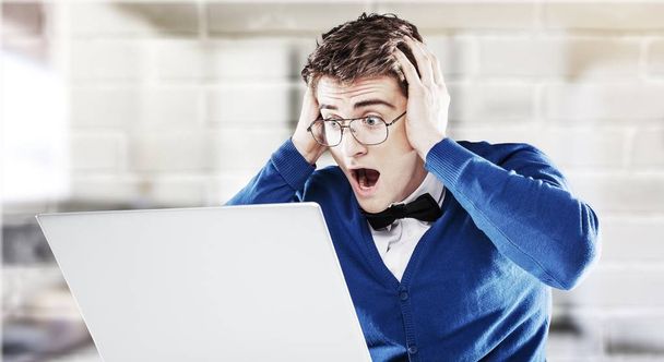 shocked young man with laptop  - Foto, Bild
