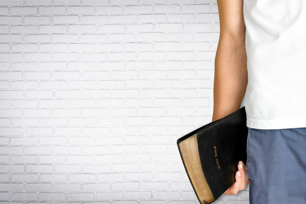 hand of person holding Bible book  - Photo, image