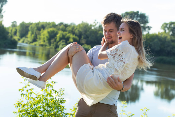 happy romantic couple in love and having fun outdoor in summer day, beauty of nature, harmony concept - Fotoğraf, Görsel