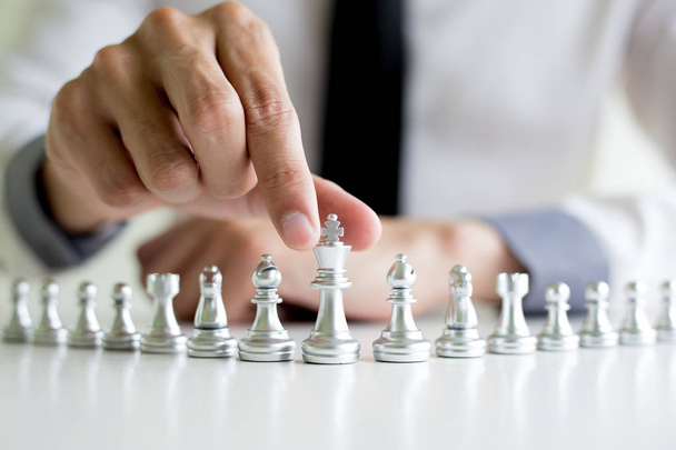A young business man is playing chess, business strategy to be s - Photo, Image