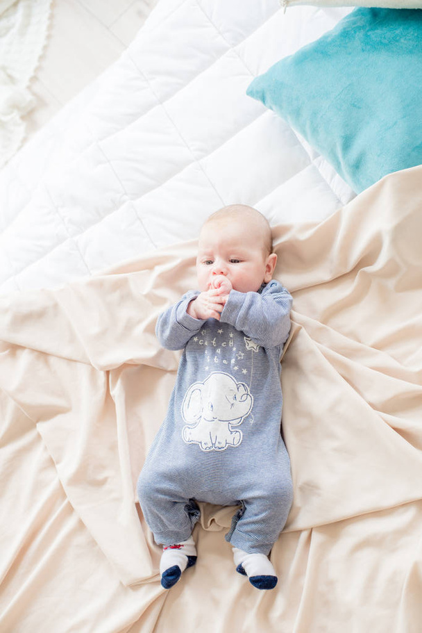 Little cute toddler is lying at home on the bed. Happy childhood - Foto, afbeelding
