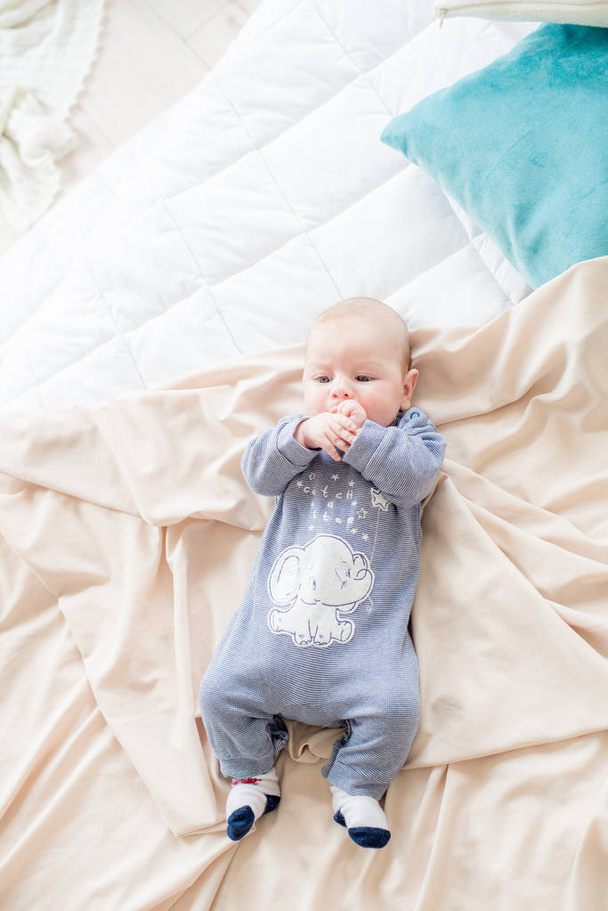 Little cute toddler is lying at home on the bed. Happy childhood - Foto, Imagen