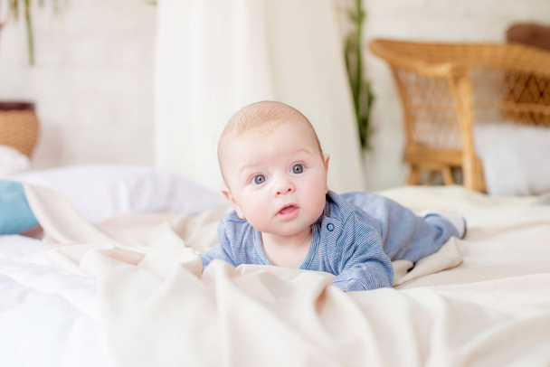 Little cute toddler is lying at home on the bed. Happy childhood - Foto, Bild