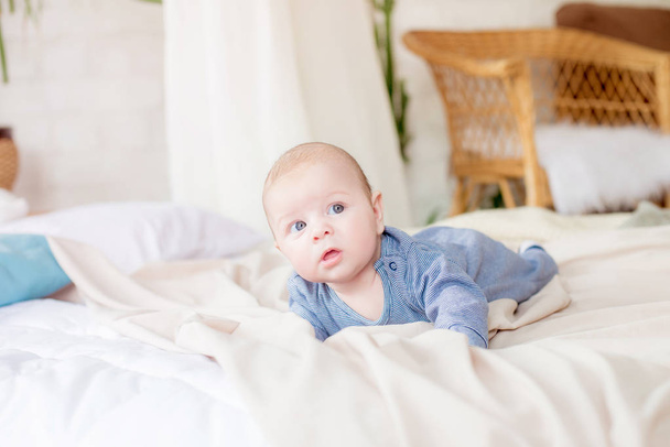 Little cute toddler is lying at home on the bed. Happy childhood - Foto, Bild