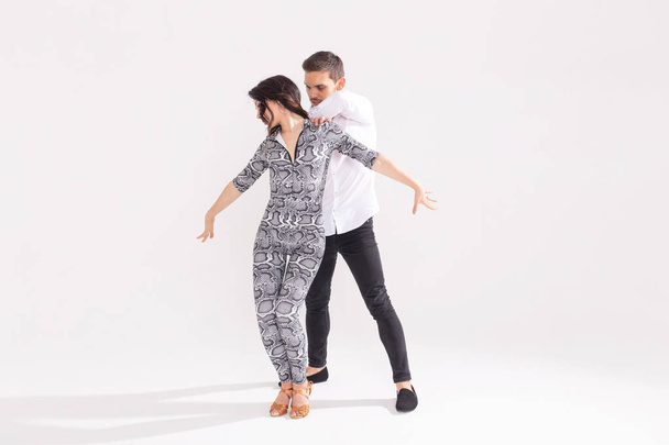Salsa, kizomba, tango and bachata dancers on white background with copy space. Social dance concept - Photo, Image
