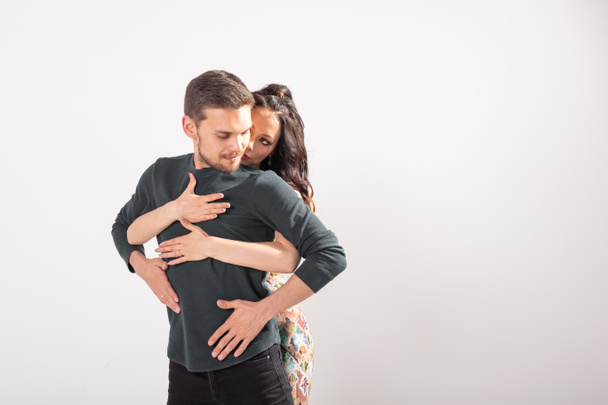 Skillful dancers performing in the white background with copy space. Sensual couple performing an artistic and emotional contemporary dance - Foto, immagini