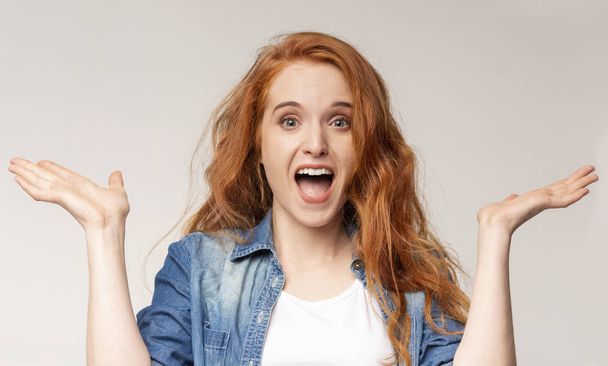 Surprised redhead girl standing with opened mouth - Photo, Image