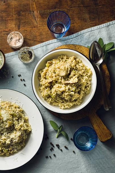 Classic Italian risotto with mushrooms on a wooden table with a  - Foto, Imagen