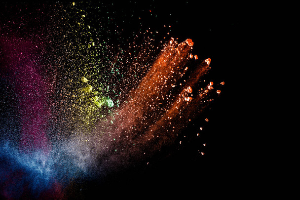 Abstract colorful dust particles textured background.Multicolored powder explosion on black background. - Fotó, kép