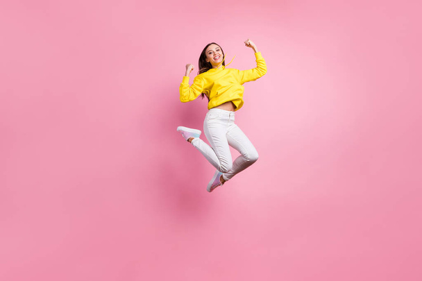 Full length body size photo of charming cheerful cute attractive girl having won some competitions while wearing yellow sweater footwear isolated over pink pastel background - Zdjęcie, obraz