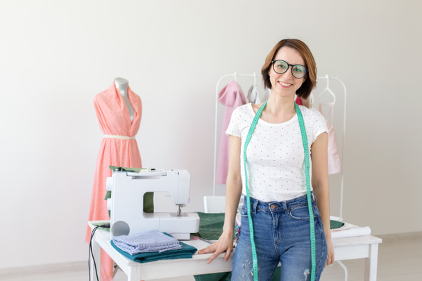 Dressmaker, fashion designer and tailor concept - Portrait of young dressmaker woman - Photo, Image