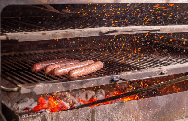 food, delicious and meat concept - roasting horse meat sausages grilled. - Photo, Image