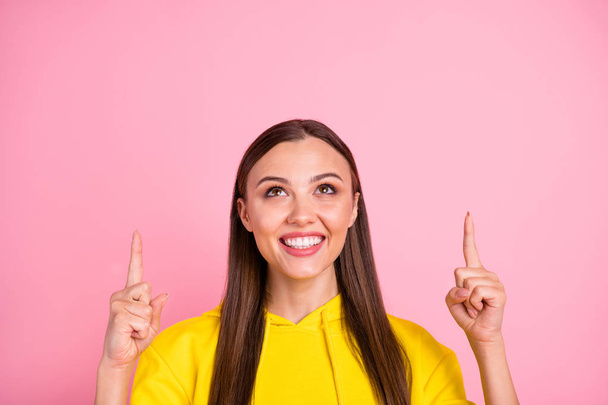 Close up photo of beautiful attractive charming sweet girlfriend wearing yellow sweater pointing up to sales indicated above while isolated over pink color pastel background - Valokuva, kuva