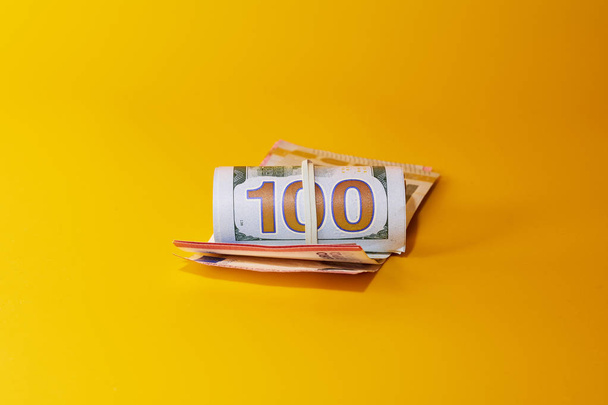 Money - dollars and euros on bright yellow background - Foto, imagen