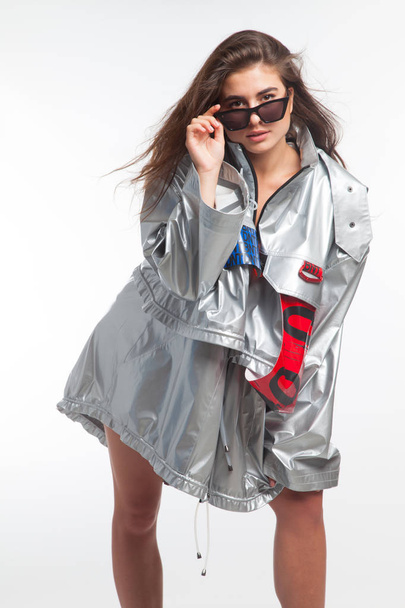 Beautiful girl, model with futuristic urban clothes, expressions of a beautiful girl on white background - Foto, imagen