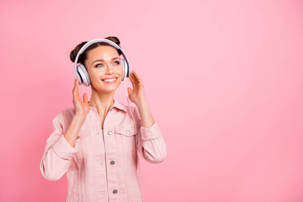 Portrait of charming lady holding headset dreaming looking up wearing pastel color jacket isolated over pink background - Φωτογραφία, εικόνα