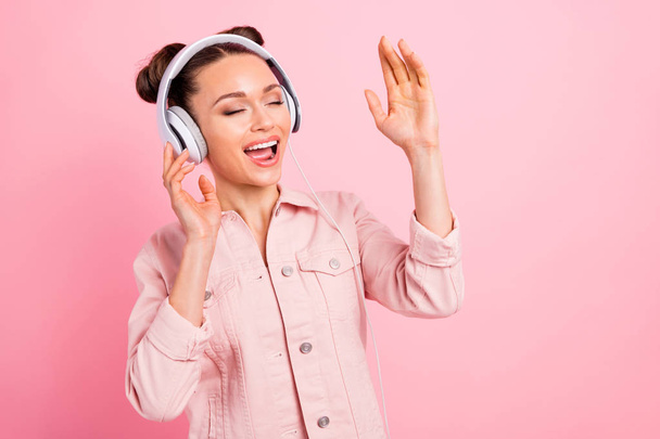 Close-up portrait of her she nice-looking attractive cheerful cheery dreamy girl enjoying new track list mp3 audio player isolated over pink pastel background - Foto, Bild