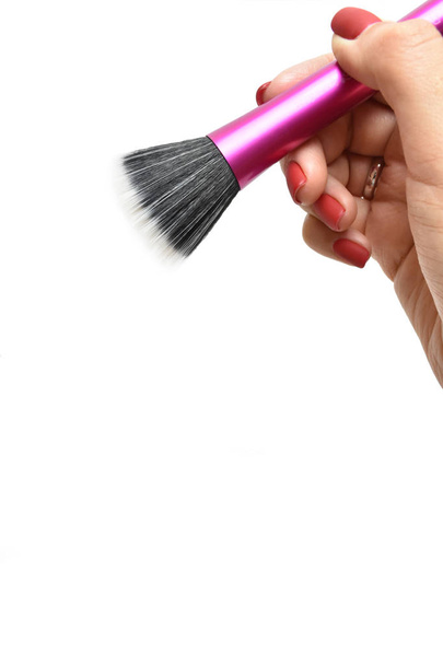 Isolated makeup brush in female hand on a white background - Photo, Image