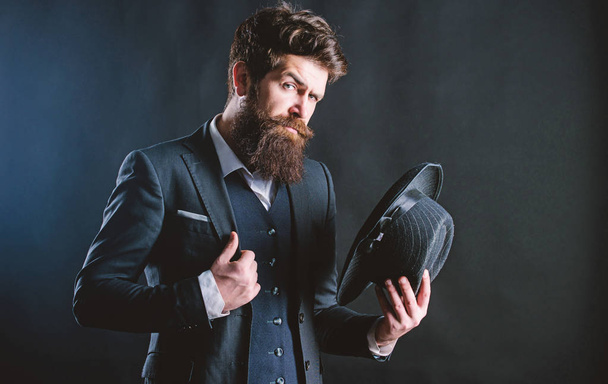 Elegant and stylish hipster. Retro fashion hat. Man with hat. Vintage fashion. Man well groomed bearded gentleman on dark background. Male fashion and menswear. Formal suit classic style outfit - Photo, Image