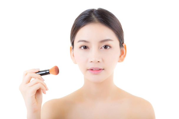 Beauty asian woman applying make up with brush isolated on white - 写真・画像