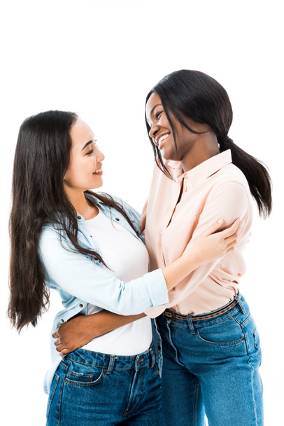 smiling asian and african american friends hugging isolated on white  - Fotografie, Obrázek