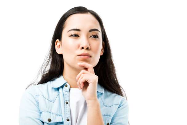 attractive and pensive asian woman in denim shirt looking away isolated on white  - Φωτογραφία, εικόνα