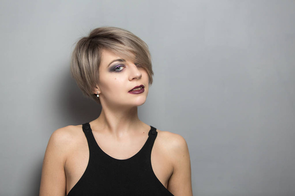 Portrait of young beautiful blonde woman with short hair - Fotó, kép