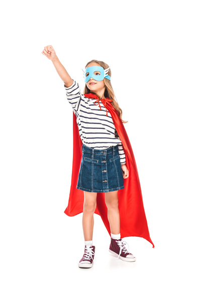 full length view of kid in mask and hero cloak holding fist up isolated on white - Foto, afbeelding
