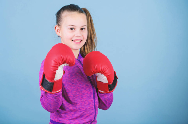 Rise of women boxers. Girl cute boxer on blue background. With great power comes great responsibility. Contrary to stereotype. Boxer child in boxing gloves. Female boxer change attitudes within sport - Fotografie, Obrázek