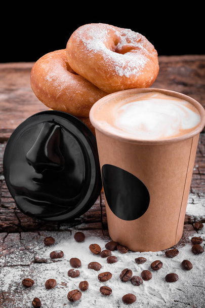 donuts sprinkled with powdered sugar next to a glass of coffee - Photo, Image