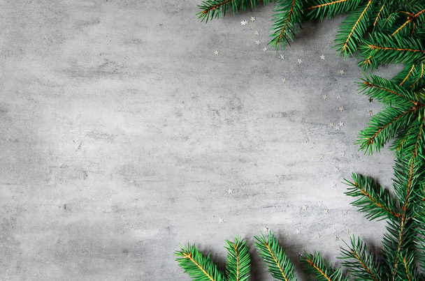 fir branches border on gray background, christmas backdrop - Photo, image