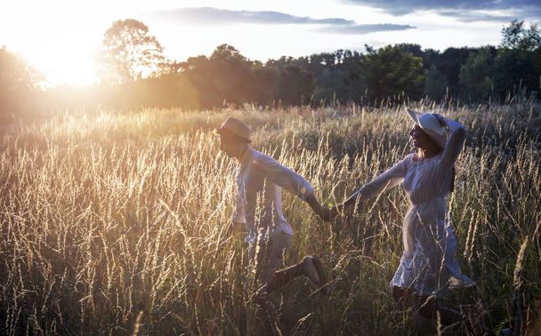 Young Couple Running Through Field - Photo, image