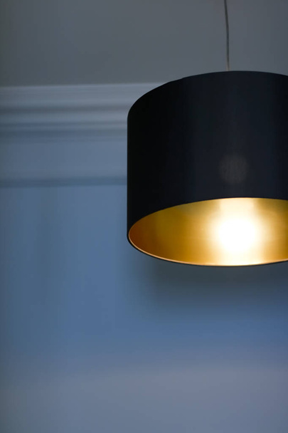 Golden lamp in a room, elegant modern home decor lighting - Fotografie, Obrázek
