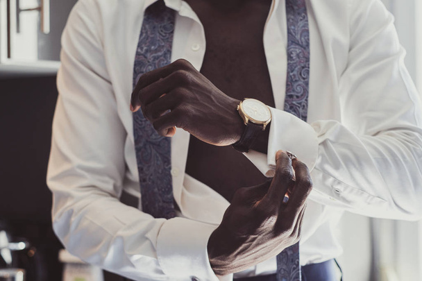 Elegant man is dressing up his cufflinks - Photo, Image