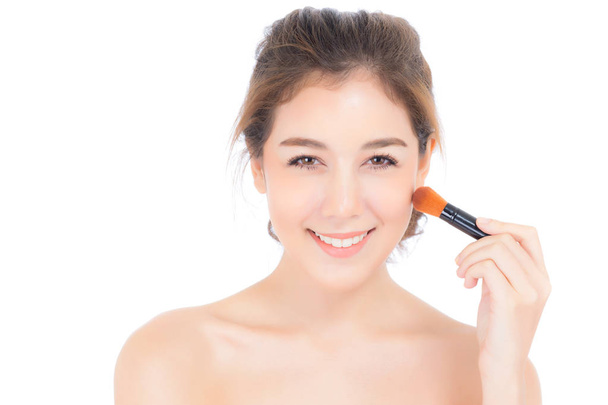 Beauty asian woman applying make up with brush of cheek isolated - Fotó, kép