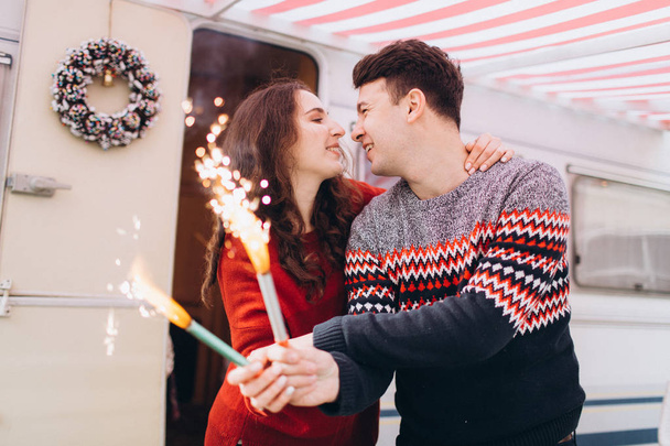 Girl friend and boyfriend friend celebrate new year setting fire to sparklers. - Photo, Image