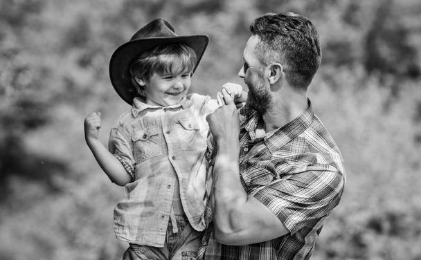 Little boy and father in nature background. Spirit of adventures. Strong like father. Power being father. Child having fun cowboy dad. Rustic family. Growing cute cowboy. Small helper in garden - 写真・画像
