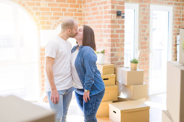 Young couple together smiling happy moving to a new house - Фото, изображение