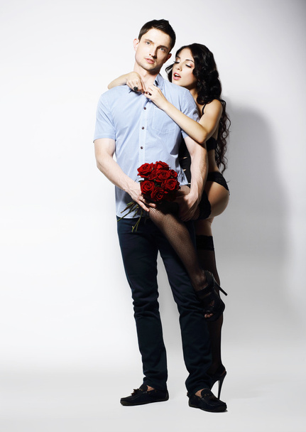 Allurement. Affectionate Romantic Couple with Bouquet of Flowers - Фото, изображение