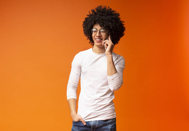 Moderno chico negro relajado hablando en el teléfono celular
 - Foto, Imagen