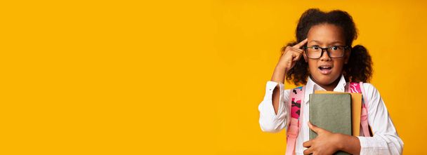 Afro School Girl Twisting Finger At Temple, Yellow Background, Panorama - Foto, Imagem
