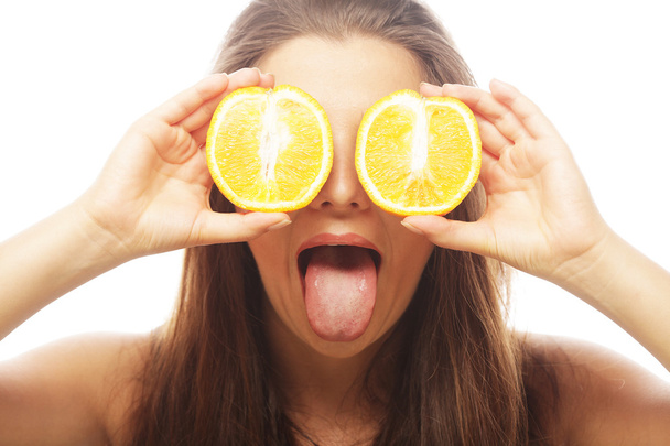 Funny girl holding oranges over eyes - Fotó, kép