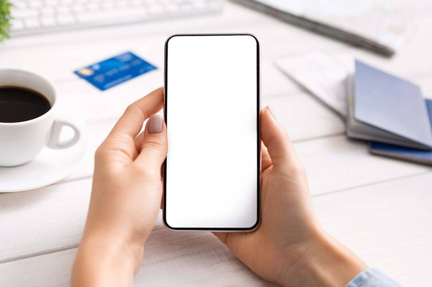 Closeup of modern smartphone with blank screen in female hands. - Zdjęcie, obraz