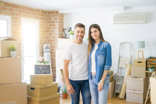 Beautiful young couple moving to a new house, smiling happy arro - Photo, Image