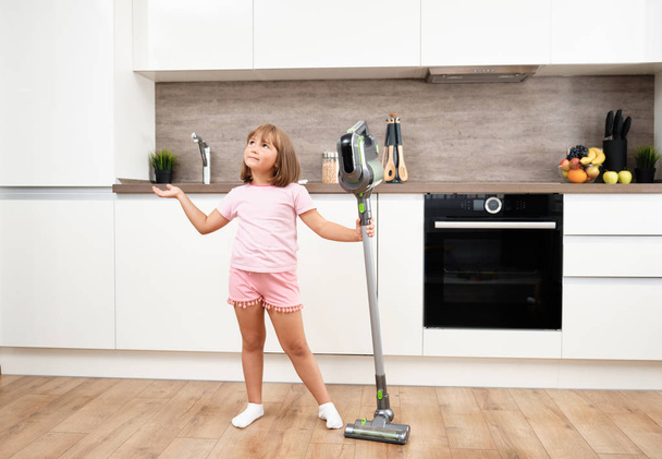 Little girl Using Vacuum Cleaner in Room. Vacuuming and Cleaning the House. Housework - Valokuva, kuva