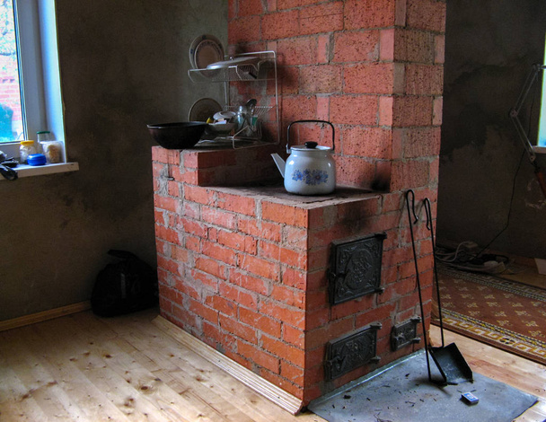  Большая кирпичная плита в загородном доме в России. большая кирпичная плита с металлическими дверями в сельском доме
 - Фото, изображение