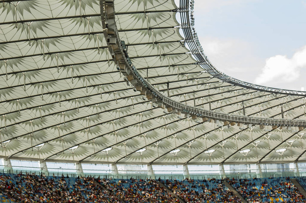 soccer stadium inside view. football field, empty stands, a crowd of fans, a roof against the sky - Фото, зображення