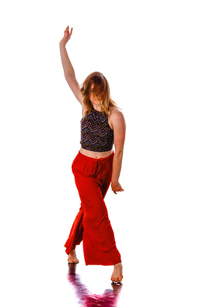 Modern active female artist dancing excited posing in studio. Sp - Photo, image